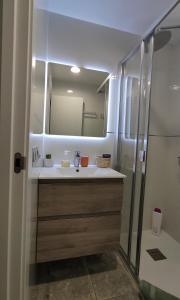 a bathroom with a sink and a mirror at Apartamento la Unión II , calidad y comodidad in Castellón de la Plana