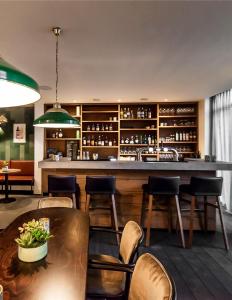 een bar in een restaurant met stoelen en een tafel bij Woonlandschap De Leyhoeve Groningen in Groningen