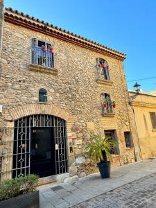 a large brick building with a door and windows at Barri Antic Cambrils in Cambrils