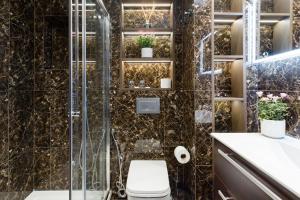 a bathroom with a shower with a toilet and a sink at The One Bramham in London
