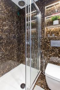 a bathroom with a shower and a toilet at The One Bramham in London