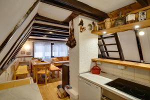 a kitchen and dining room in a tiny house at Story Mountain Chalet in Jahorina