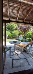 a patio with a table and chairs on a stone patio at Esperides Villa in Sani Beach