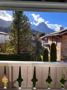 a window of a house with a view of a yard at Alpsoul eine Ferienwohnung mit Charisma…. in Garmisch-Partenkirchen