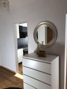 a mirror on top of a dresser in a bedroom at Alpsoul eine Ferienwohnung mit Charisma…. in Garmisch-Partenkirchen