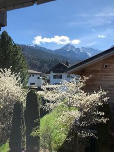 a view of a house with mountains in the background at Alpsoul eine Ferienwohnung mit Charisma…. in Garmisch-Partenkirchen