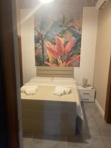 ナポリにあるB＆B シェ モアのベッドルーム1室(ベッド2台付)が備わります。壁には絵画が飾られています。