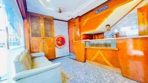 a man standing at the counter of a restaurant at HALF MOON INN in Chennai