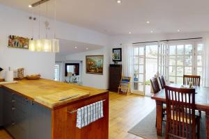 a kitchen with a counter and a dining room at Lesal Villas Rentals, Villa Mar Azul, Tossa de Mar in Tossa de Mar