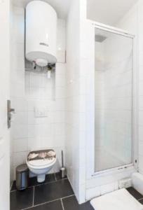 a white bathroom with a toilet and a shower at Splendid Studio 1 - Edouard Vaillant in Pantin