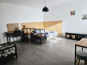 a room with a bed and a desk and a table at Le studio de Max - Terrasse et Parking in Valence