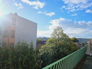 a view from a balcony of a building and trees at Le studio de Max - Terrasse et Parking in Valence