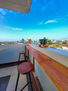 a bar with two stools and a view of the ocean at Fefe's home in Dar es Salaam