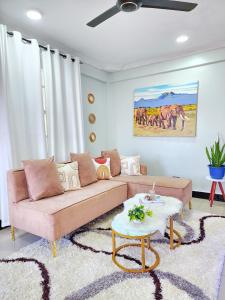 a living room with a couch and a table at Fefe's home in Dar es Salaam