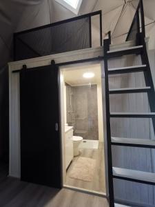 a bunk bed in a room with a bathroom at Nature Nest Aljezur in Aljezur