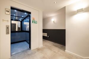 a hallway with a glass door in a building at Hausd - Soho in London +24 photos