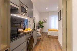 a kitchen with a sink and a stove top oven at Bonito Loft en Barrio de Chamberi Quevedo I in Madrid
