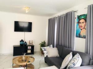 a living room with a couch and a table at A&F Cottage with pool n braai in Sandton