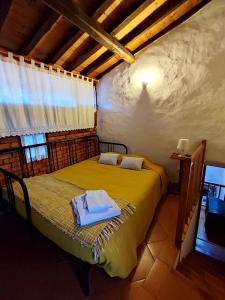 a bedroom with a bed with a towel on it at Casa do Forno in Valezim