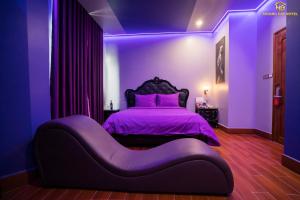 um quarto roxo com uma cama com um visor roxo em Hoàng Gia Hotel Tuy Hoà em Tuy Hoa