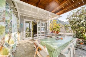 a house with a table and chairs on a patio at Magical View Studios 1 Asproneri, Kamena Vourla in Kamena Vourla