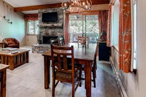 a dining room with a table and a fireplace at 5123 Foxtail in Wilson