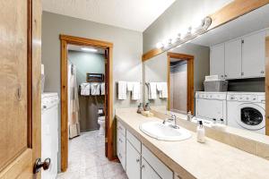 a bathroom with a sink and a washing machine at 5123 Foxtail in Wilson +18 photos