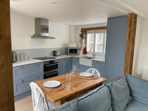 a kitchen with a table with two plates on it at The Stable at Thornlea in Axminster