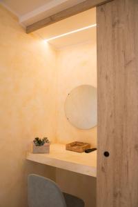 a room with a shelf with a mirror and a chair at Albergo Ristorante Da Elia in SantʼOmobono Imagna