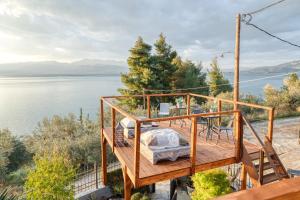 a wooden deck with a view of the water at Magical View Studios 1 Asproneri, Kamena Vourla in Kamena Vourla