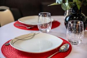 a table with a white plate and a red napkin at Stylin In The Smokies by Distinctive Getaways in Gatlinburg