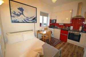 a kitchen with a bed and a table in a room at Corbyn Street Flat 2 in London