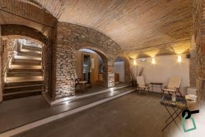 a room with a stone wall and a staircase at HOTIDAY Hotel Firenze Centro in Florence