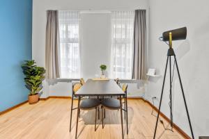 a dining room with a table and a telescope at primeflats - Apartment Leberstr 58 Berlin Schöneberg in Berlin +17 photos