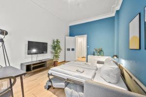a room with two beds and a flat screen tv at primeflats - Apartment Leberstr 58 Berlin Schöneberg in Berlin