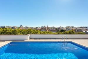 a swimming pool with a view of the city at Paseo del Prado III Museum area for two in Madrid