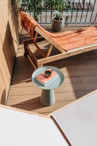 a table on a balcony with a bowl on it at Room Mate Oliveira - City Centre, Valencia in Valencia +32 photos