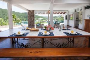 a large wooden table with food on top of a house at Villa "The Pretty Mermaid", pool and stunning views 5 min from beach in Deshaies