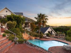 a house with a swimming pool and stairs at Dunvegan Lodge in Clovelly