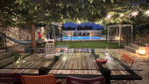 a table in a backyard with a soccer field at Splendid Gouvia Villa 3 Bedrooms Villa Yiarios Private Playground in Pouládes