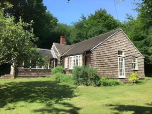 an old house with a yard in front of it at 3 Bed Cabin in the Woods in Barham