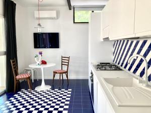 a kitchen with a blue and white checkered floor at Maison Blue con Patio in Fregene
