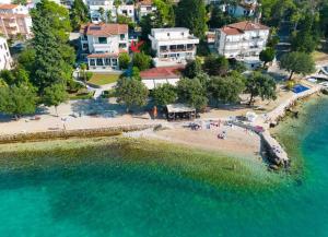 an aerial view of a beach with people in the water at Apartments Škarpa in Malinska