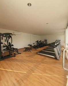 a gym with several treadmills and exercise bikes at Jira Private cozy room near Suvarnabhumi Airport in Lat Krabang