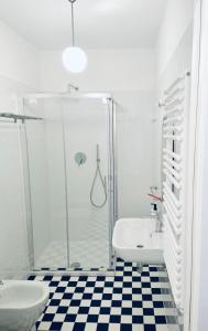 a bathroom with a shower and a toilet and a sink at Maison Blue con Patio in Fregene +16 photos