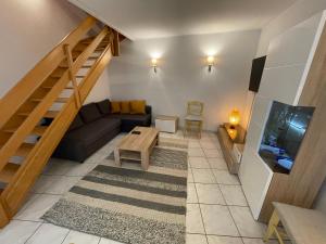 a living room with a couch and a table at Superbe logement à proximité du centre et du Kirchberg in Luxembourg