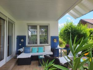 porche con banco y almohadas azules y blancas en Haus Obere Weinburg, en Radolfzell am Bodensee