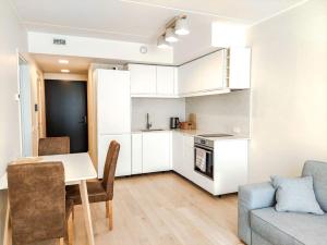 a kitchen and living room with a table and a couch at Mai 71 Johanna suvekorter in Pärnu