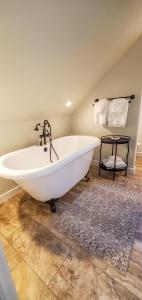 een wit bad in een badkamer met een tapijt bij Walnut Hill Estate in West Jefferson