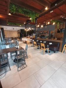 a restaurant with tables and chairs and a bar at Hotel Plaza in Colón